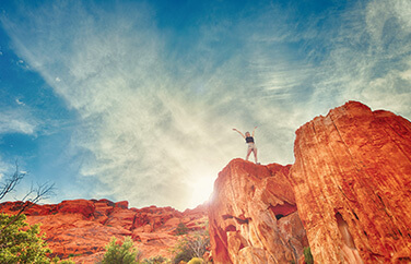 Image of a hiker at the top of trail