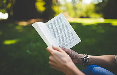 Image of a man reading a book