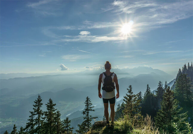 Image of a person reaching summit of mountain